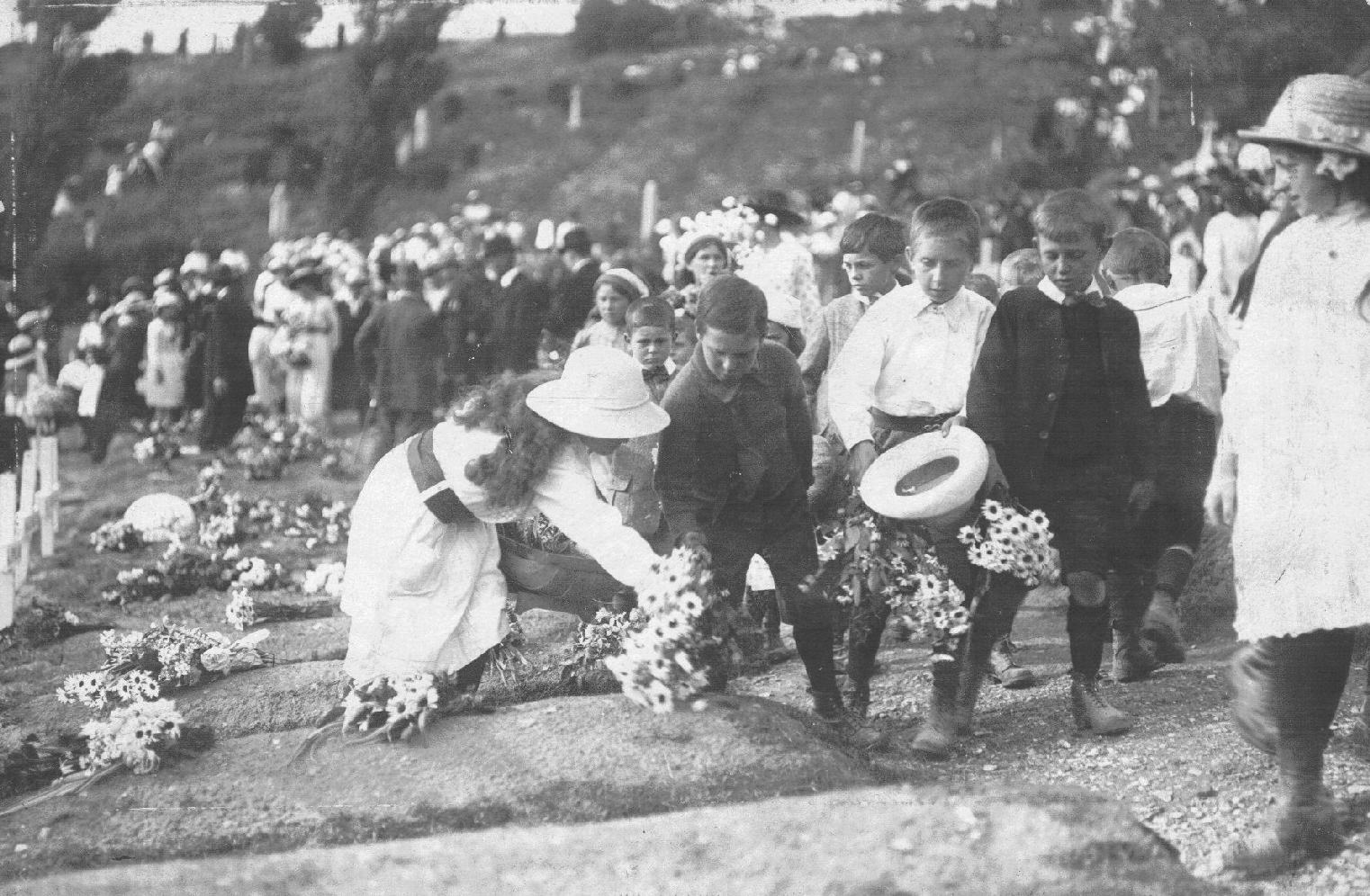Children laying flowers in Shorncliffe Military Ceremony in Kent on the first Canada Day