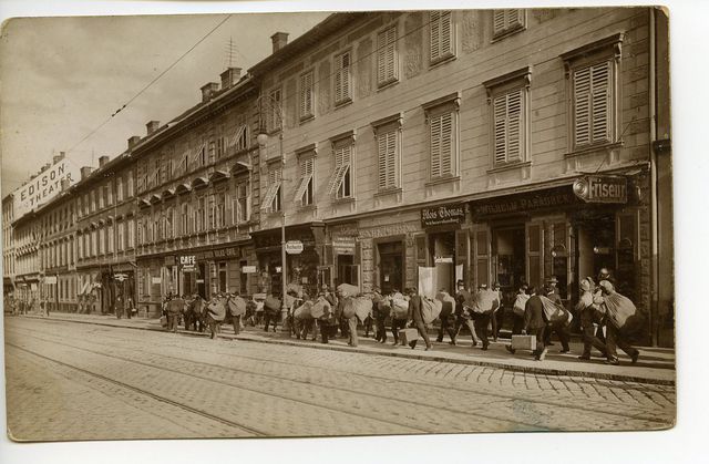 A line of men walking down a street