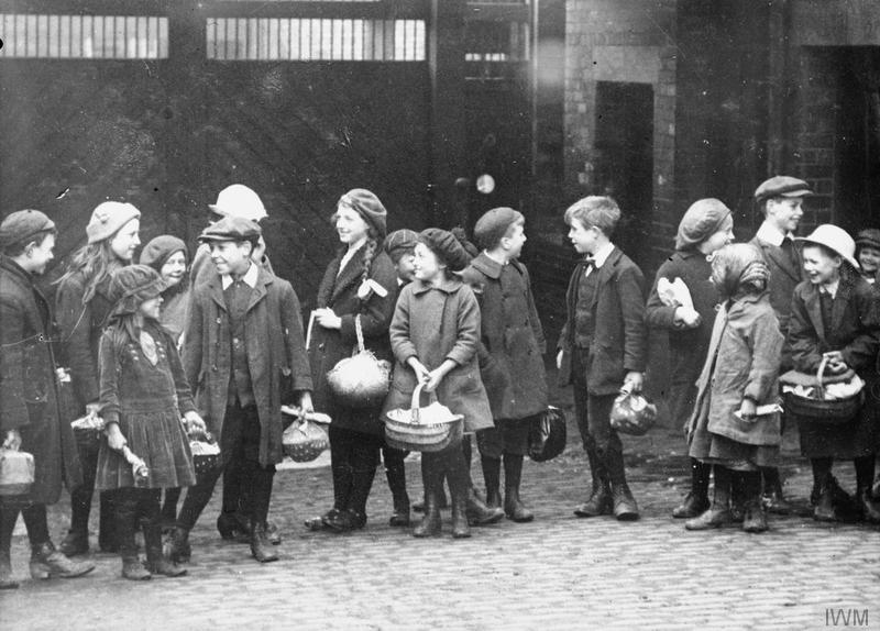 Young children wait outside Swan, Hunter and Wigham Richardson Ltd shipbuilding yard to deliver food to their relatives, Wallsend, Newcastle.