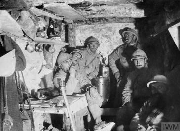 French soldiers of the 68th Infantry Regiment rest in their dugout at Artois, October 1915. © IWM (Q 49296)