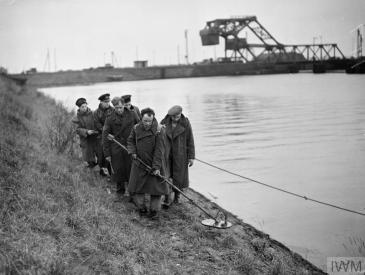 Men making a path through landmines in Antwerp, Belgium