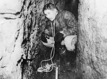 Officer of the French Army Engineers listening to the sound of enemy operations with a microphone in the underground tunnel.