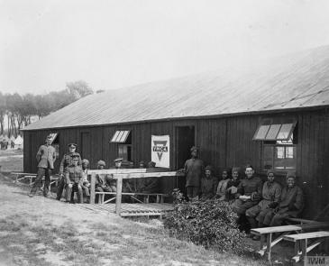Group of British soldiers and members of the Egyptian Labour Corps outside an YMCA hut at Dunkerque, 24 May 1917.